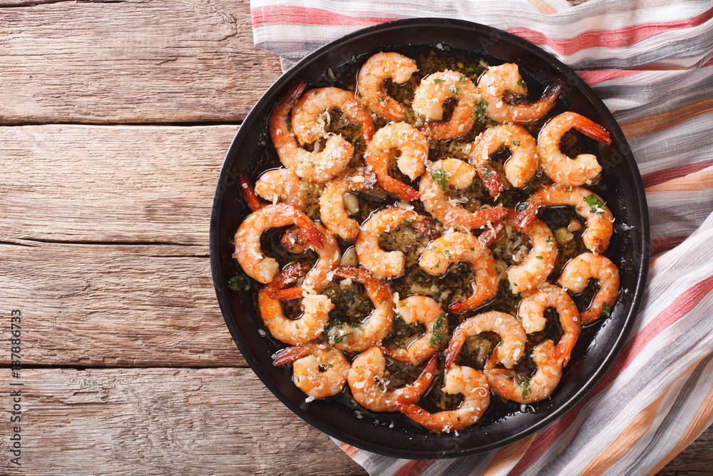 Canvas Prints shrimp in garlic sauce with parmesan cheese and herbs in a pan close-up. horizontal top view