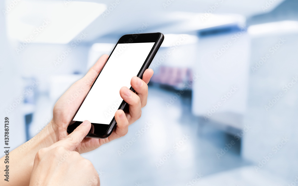 Poster Hand click mobile phone with blur seminar hall room background bokeh light,White screen mock up template for adding your design or your text