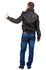 Back view of  man shows thumbs up.