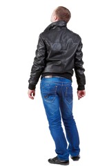 Fototapeta premium Back view of handsome man in jacket looking up.