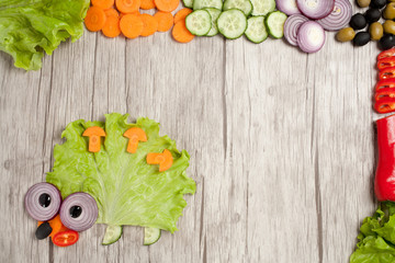 Hedgehog made of fresh vegetables on table with ingredients