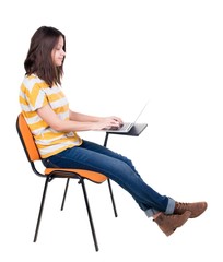 Side view of  woman sitting on a chair to study with  laptop.