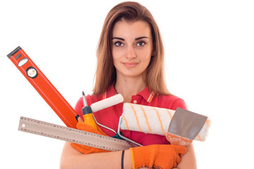 a young girl holds a variety of tools for repairing close-up isolated on white background