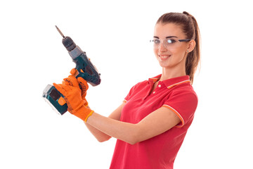 young girl in goggles holding a drill is isolated on a white background