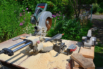 Circular saw and other tools on background of nature in summer