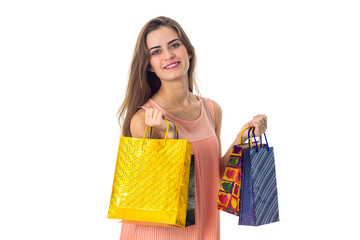 smiling girl holds a different gift bags isolated on white background