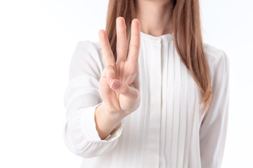 girl stretched forth a hand and three fingers shows close-up