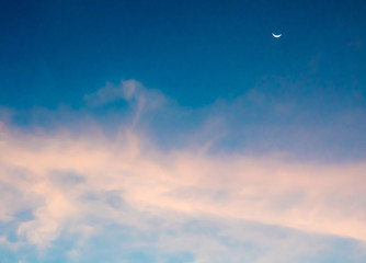Crescent moon and clouds in the sky