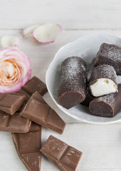 Chocolate and curd cheese at wooden background 