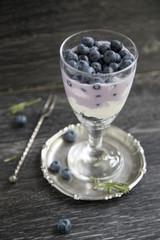 Fototapeta na wymiar Cup with blueberry and smoothies on a wooden background 
