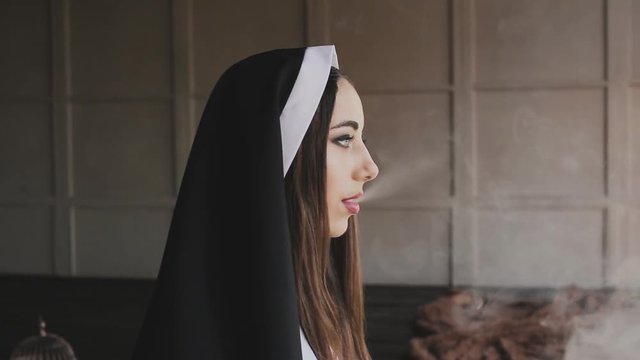bad nun smoking a cigarette