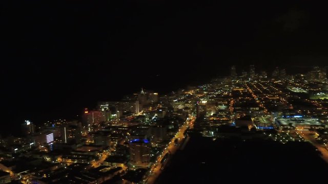 Miami Aerial v43 Flying over Miami Beach panning at night.