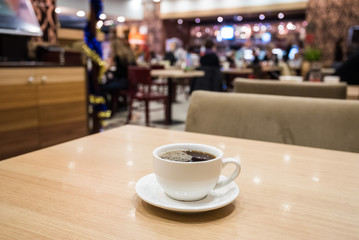 Teapot and cup of tea in cafe