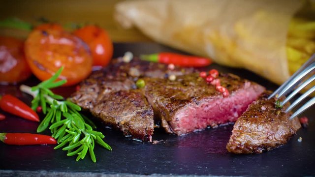 big tasty steak on stone plate