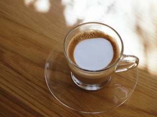 A glass of latte coffee.
