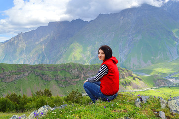 Fototapeta na wymiar Happy tourist on the background of the Caucasus mountains