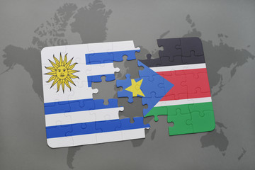 puzzle with the national flag of uruguay and south sudan on a world map
