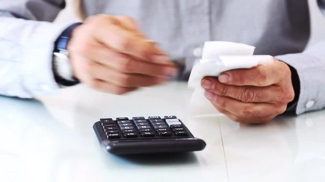 Man hands with bills and calculator