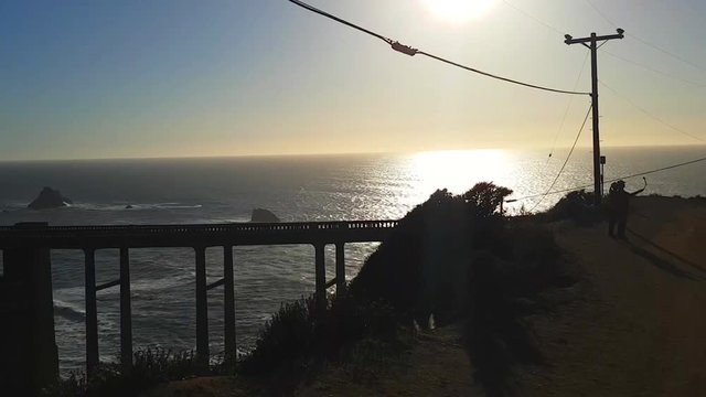 Zoom out pan timelapse of Bixby Creek Bridge, at a evening in Big sur coast, California, United states of america