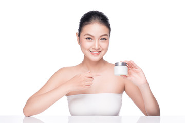 Beauty treatment. Asian woman holding moisturizing cream box.