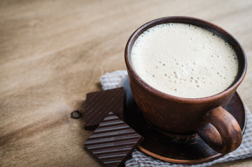 Cup of Cappuccino With a Piece of Chocolate.