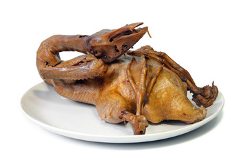 Steamed pot-stewed duck in brown sauce on white background.