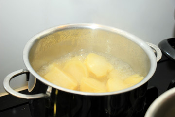 Boiling potatoes in a pan