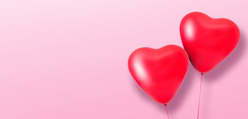 Love heart balloons on pink background