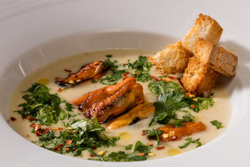 Oyster cream soup with croutons and parsley