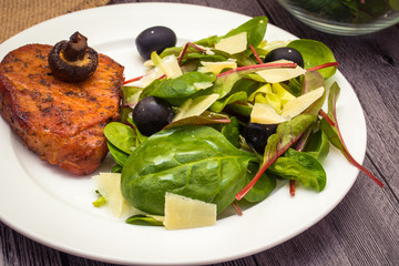 Pork steak with salad. Spinach, red valerian and chard salad