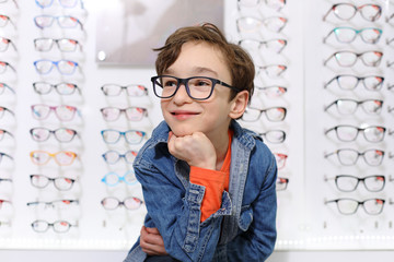 boy in glasses , at optics store

