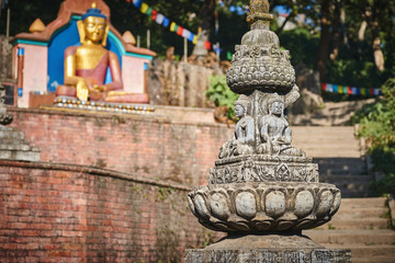 Statues of Buddha in meditation at the entrance of the Swayambhunath temple complex in Kathmandu, Nepal