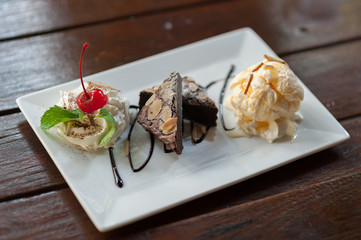 One tempting brownie ice cream sundae with cherries.