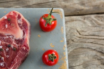 Sirloin steak and cherry tomatoes on board 