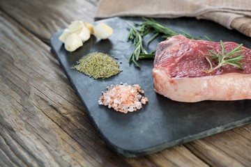 Sirloin chop and ingredients on slate board 