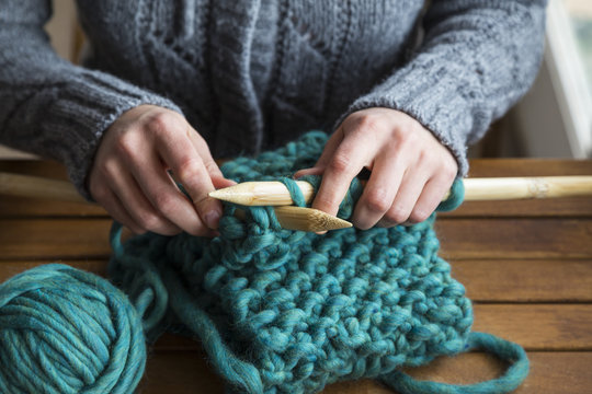 Woman knitting scarf