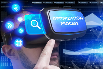 Business, Technology, Internet and network concept. Young businessman working in virtual reality glasses sees the inscription: Optimization process