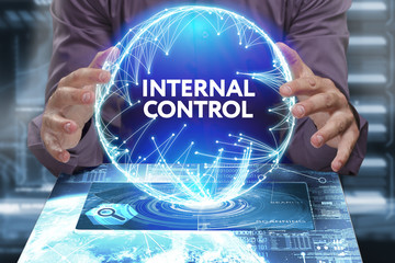 Business, Technology, Internet and network concept. Young businessman shows the word on the virtual display of the future: Internal control