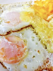 Fototapeta na wymiar Low carb breakfast with fried eggs and melted cheese