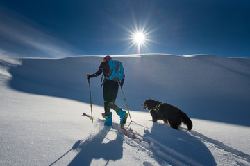 Girl makes ski mountaineering with his dog