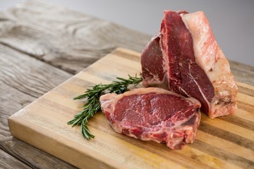 Sirloin chop on wooden tray against wooden background