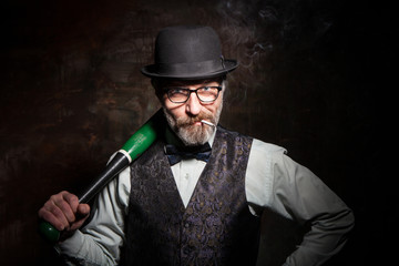 A bearded man in a bowler hat with a baseball bat