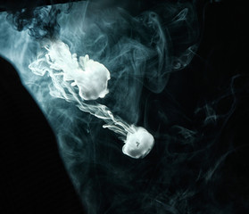 Vape trick smoke ring on dark background