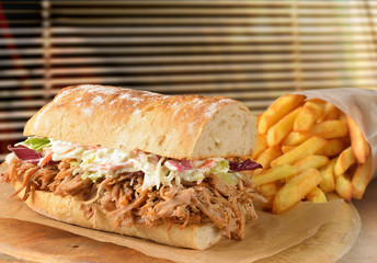 Submarine sandwich pulled pork with coleslaw fries.