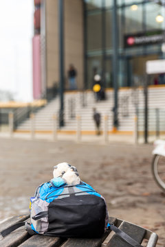 Travel concept of child backpack on bench of train station