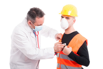 Doctor listening to constructors breath with stethoscope