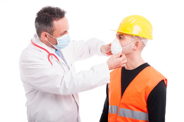 Male doctor arranging mark on constructor face