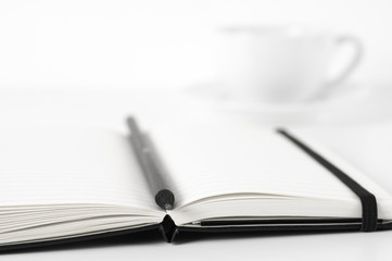 Notepads with pen and coffee