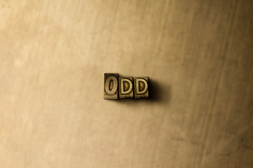 ODD - close-up of grungy vintage typeset word on metal backdrop. Royalty free stock illustration.  Can be used for online banner ads and direct mail.
