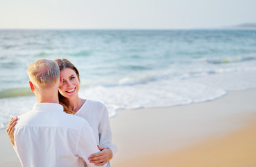 Young loving couple on the sea beach.